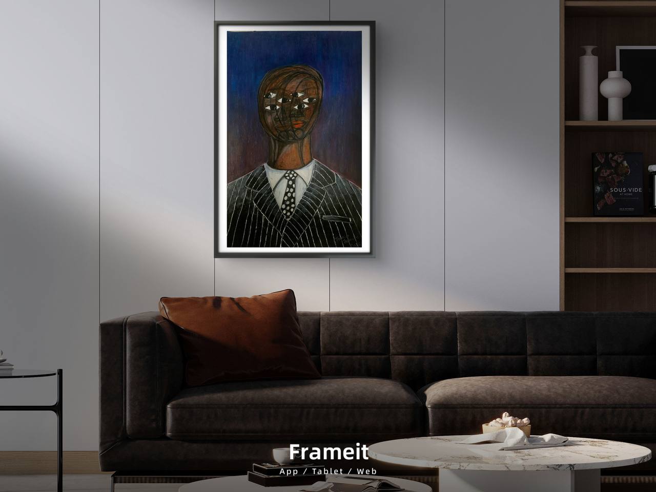 Framed artwork on a wall above a sofa in a living room setting